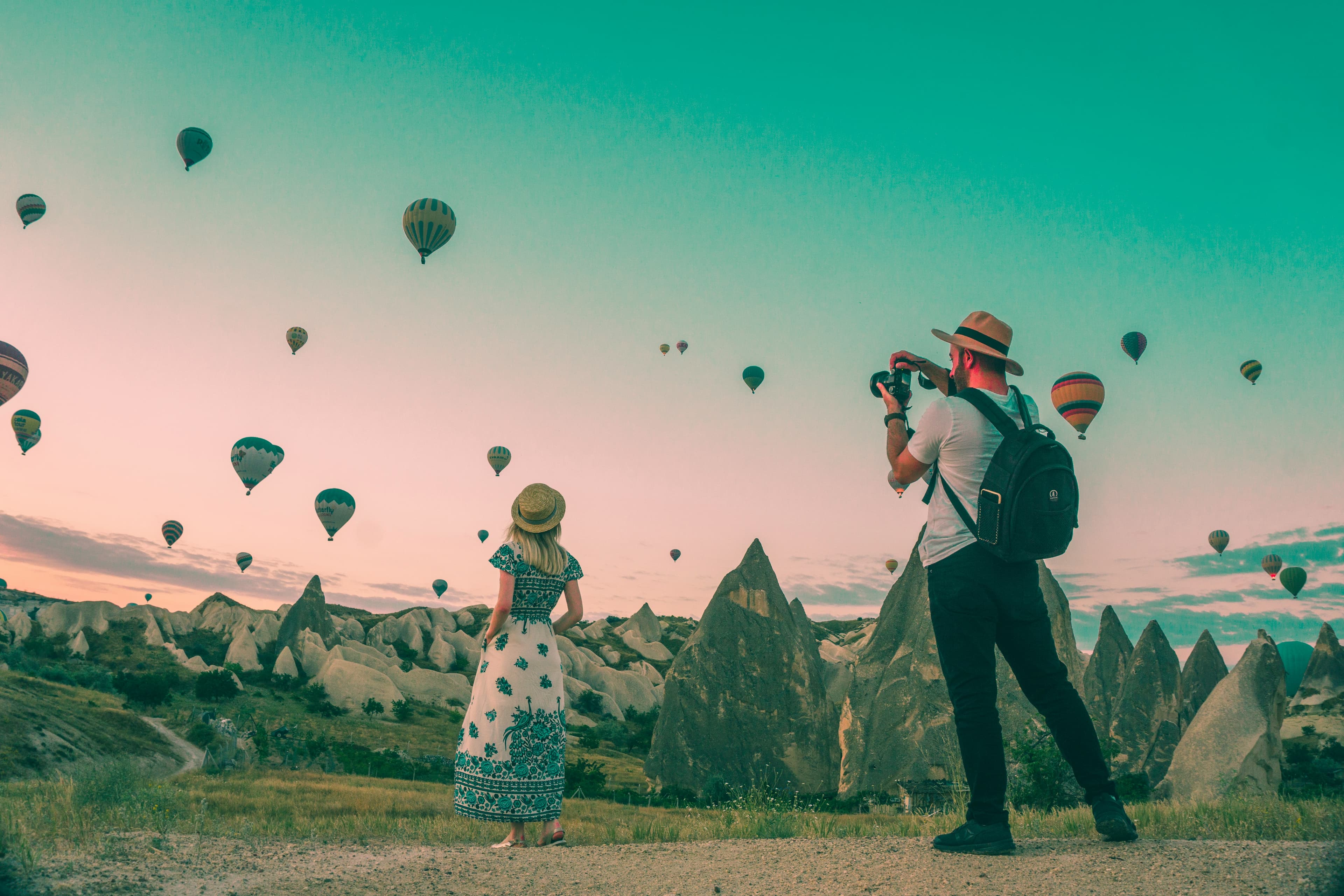 Travellers watching hot air balloons over Cappadocia